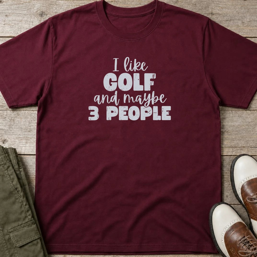 I Like Golf T-Shirt in Maroon lying on a plain floor. T-shirt is a unisex cut and 100 per cent cotton.