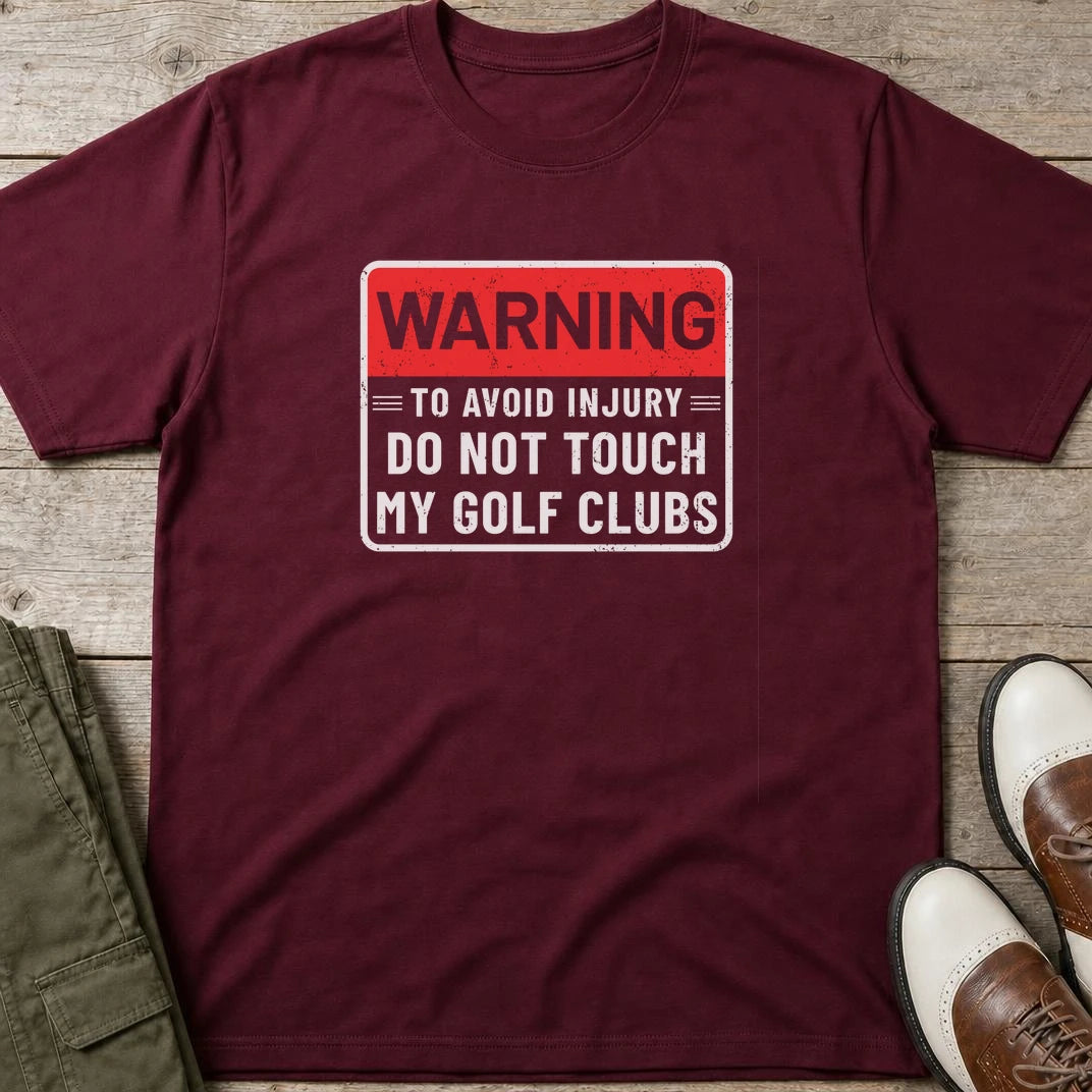 To Avoid Injury T-Shirt in Maroon lying on a plain floor. T-shirt is a unisex cut and 100 per cent cotton.