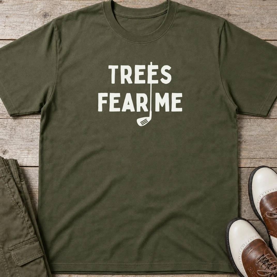 Trees Fear Me T-Shirt in Military Green lying on a plain floor. T-shirt is a unisex cut and 100 per cent cotton.
