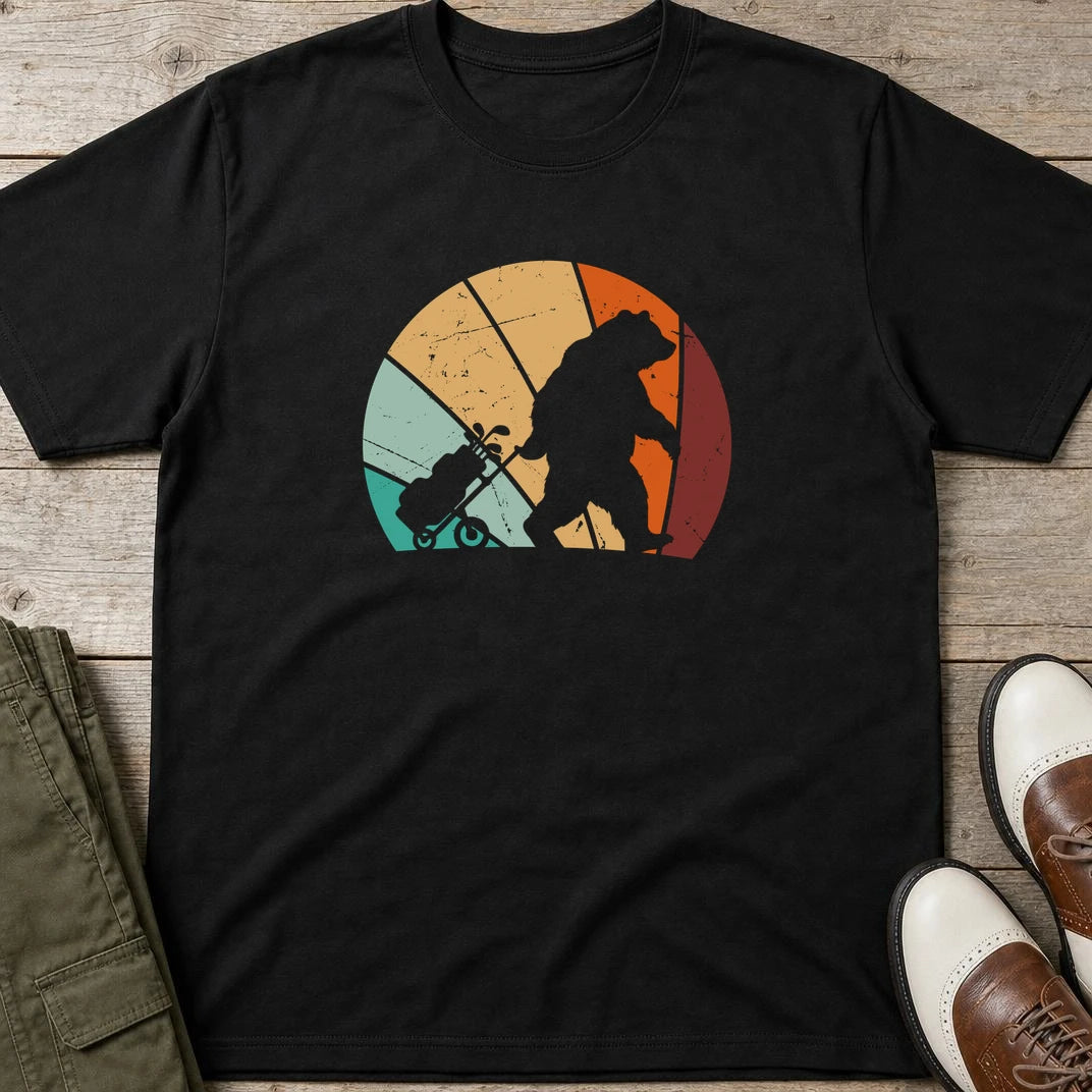 Trolley Bear T-Shirt in Black lying on a plain floor. T-shirt is a unisex cut and 100 per cent cotton.