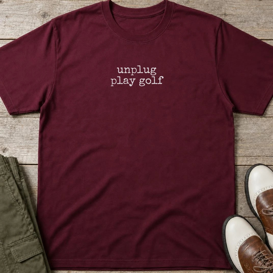 Unplug T-Shirt in Maroon lying on a plain floor. T-shirt is a unisex cut and 100 per cent cotton.