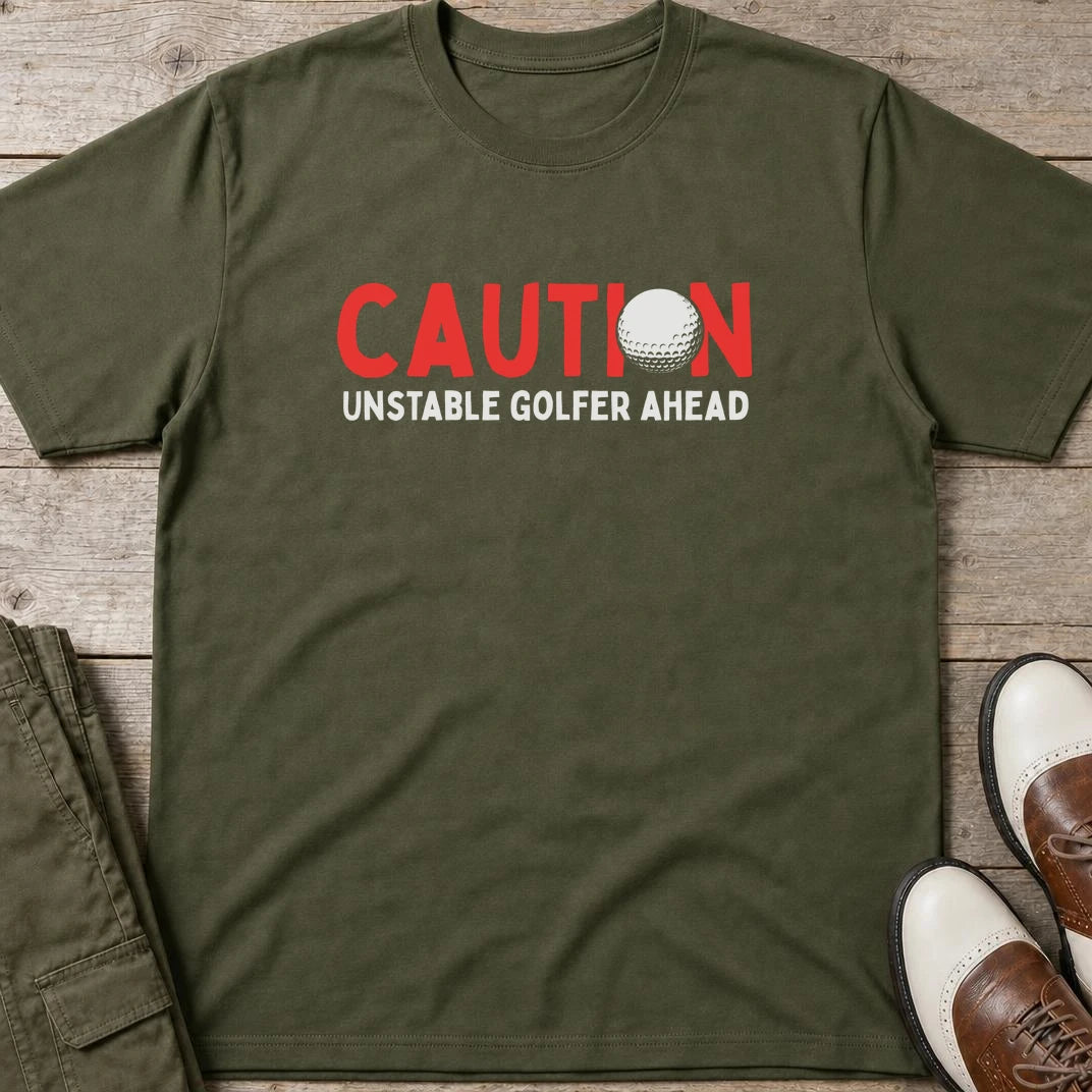 Unstable Golfer T-Shirt in Military Green lying on a plain floor. T-shirt is a unisex cut and 100 per cent cotton.
