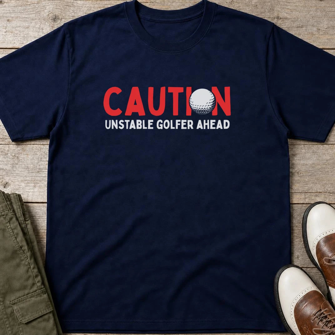 Unstable Golfer T-Shirt in Navy lying on a plain floor. T-shirt is a unisex cut and 100 per cent cotton.