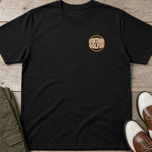 Vintage Golfer Pocket T-Shirt in Black lying on a plain floor. T-shirt is a unisex cut and 100 per cent cotton.
