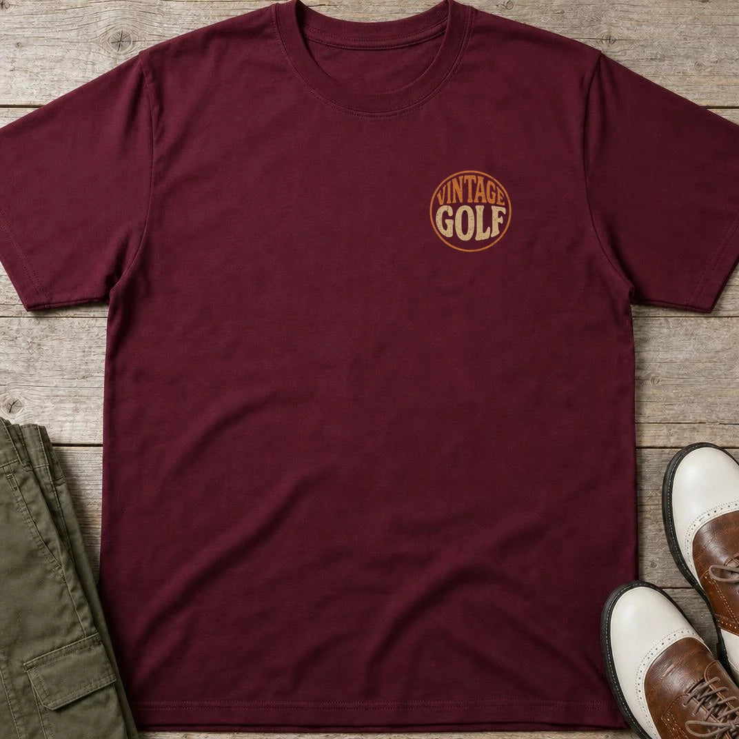 Vintage Golf Pocket T-Shirt in Maroon lying on a plain floor. T-shirt is a unisex cut and 100 per cent cotton.