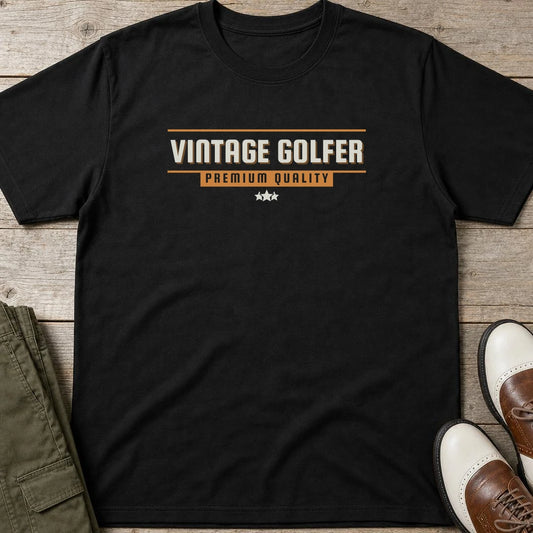 Vintage Golfer Quality T-Shirt in Black lying on a plain floor. T-shirt is a unisex cut and 100 per cent cotton.
