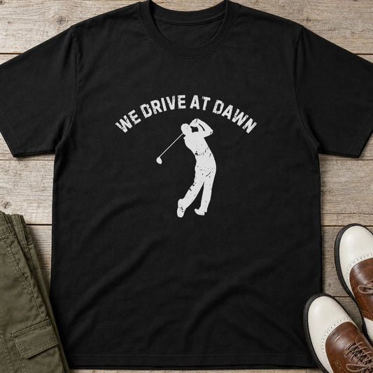 We Drive T-Shirt in Black lying on a plain floor. T-shirt is a unisex cut and 100 per cent cotton.