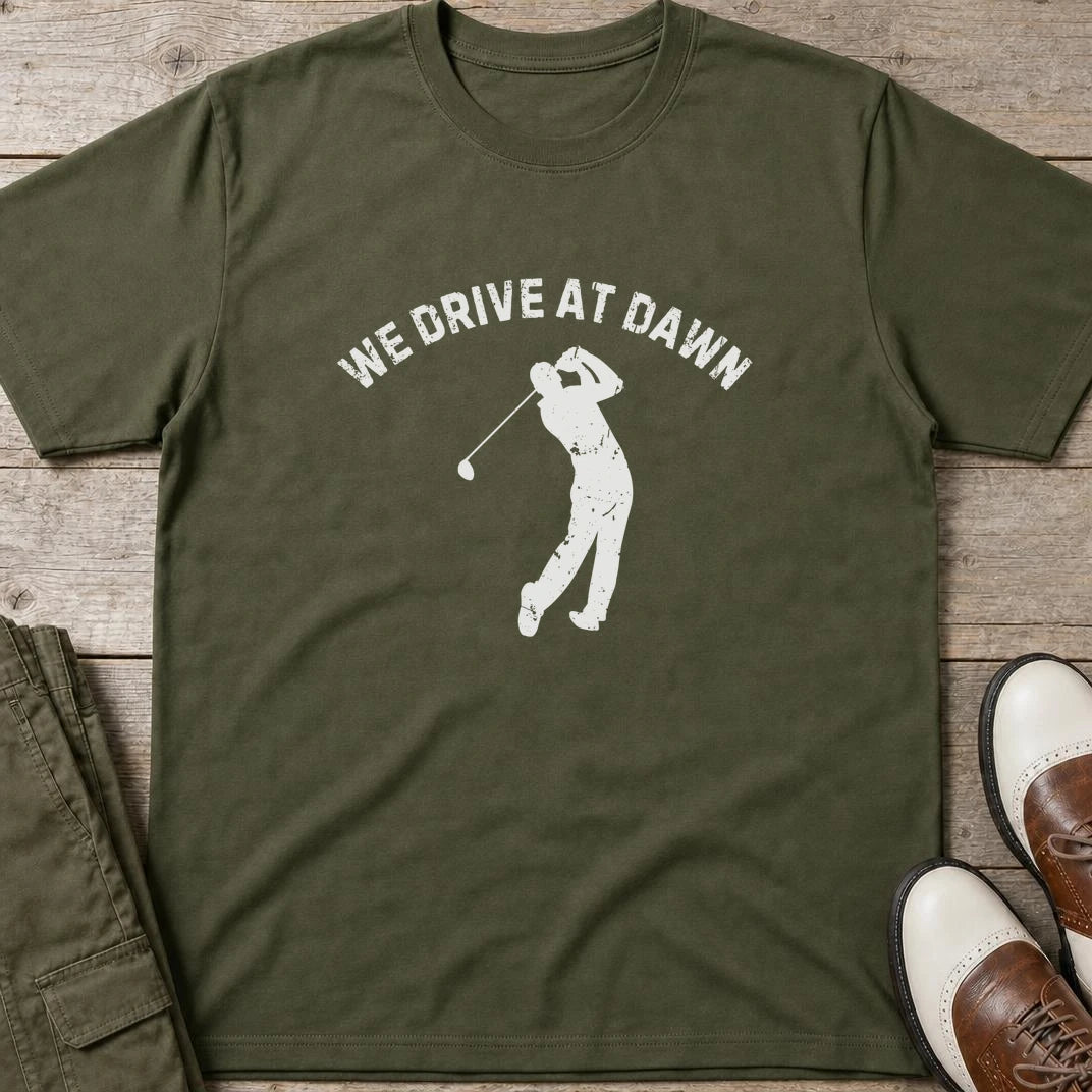 We Drive T-Shirt in Military Green lying on a plain floor. T-shirt is a unisex cut and 100 per cent cotton.