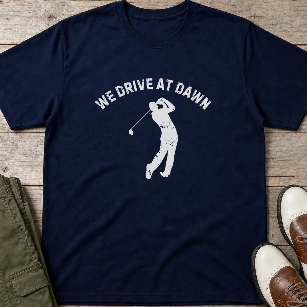 We Drive T-Shirt in Navy lying on a plain floor. T-shirt is a unisex cut and 100 per cent cotton.