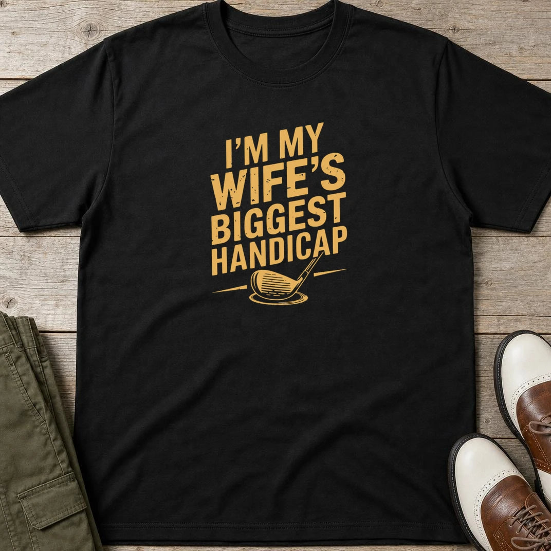 Biggest Handicap T-Shirt in Black lying on a plain floor. T-shirt is a unisex cut and 100 per cent cotton.