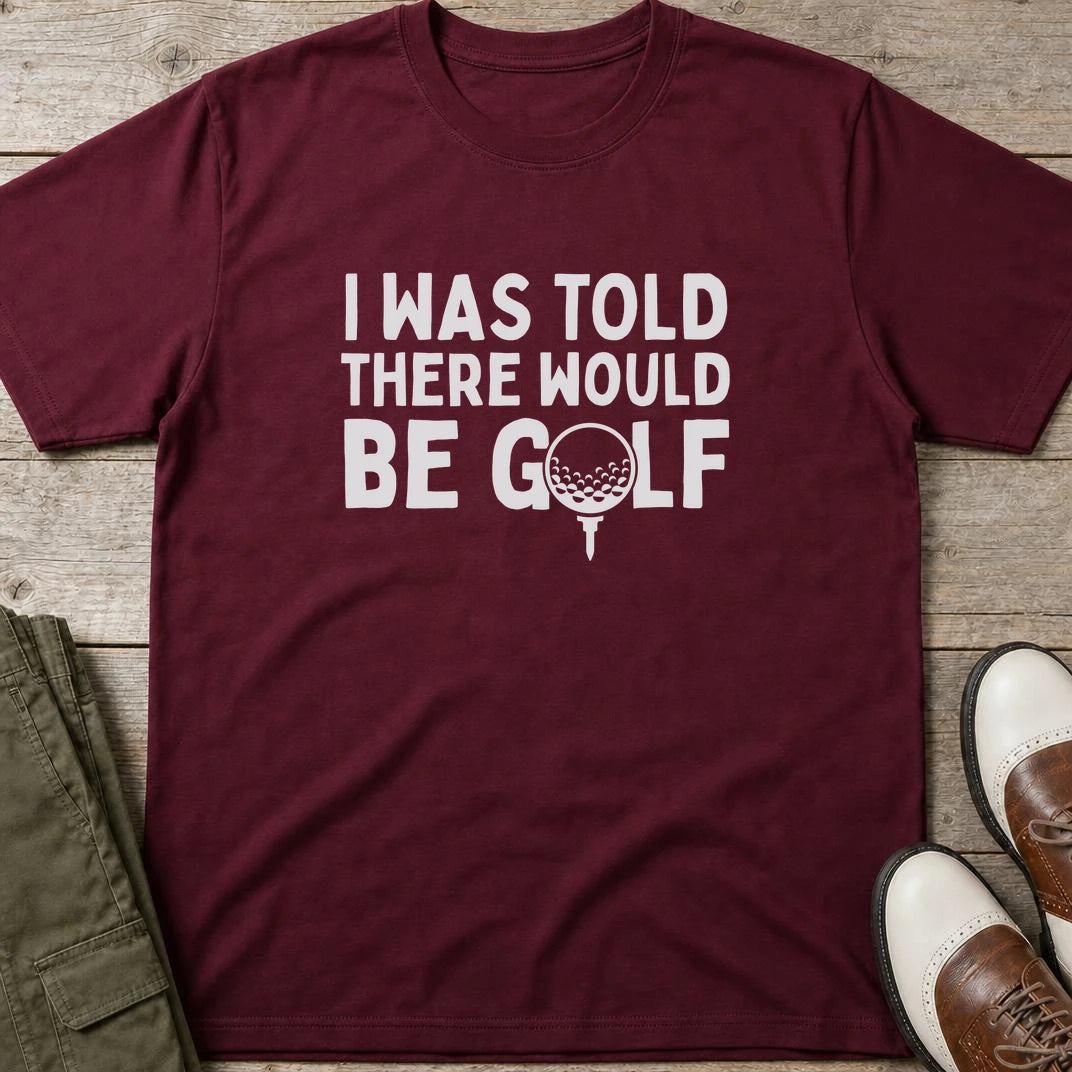 I Was Told T-Shirt in Maroon lying on a plain floor. T-shirt is a unisex cut and 100 per cent cotton.
