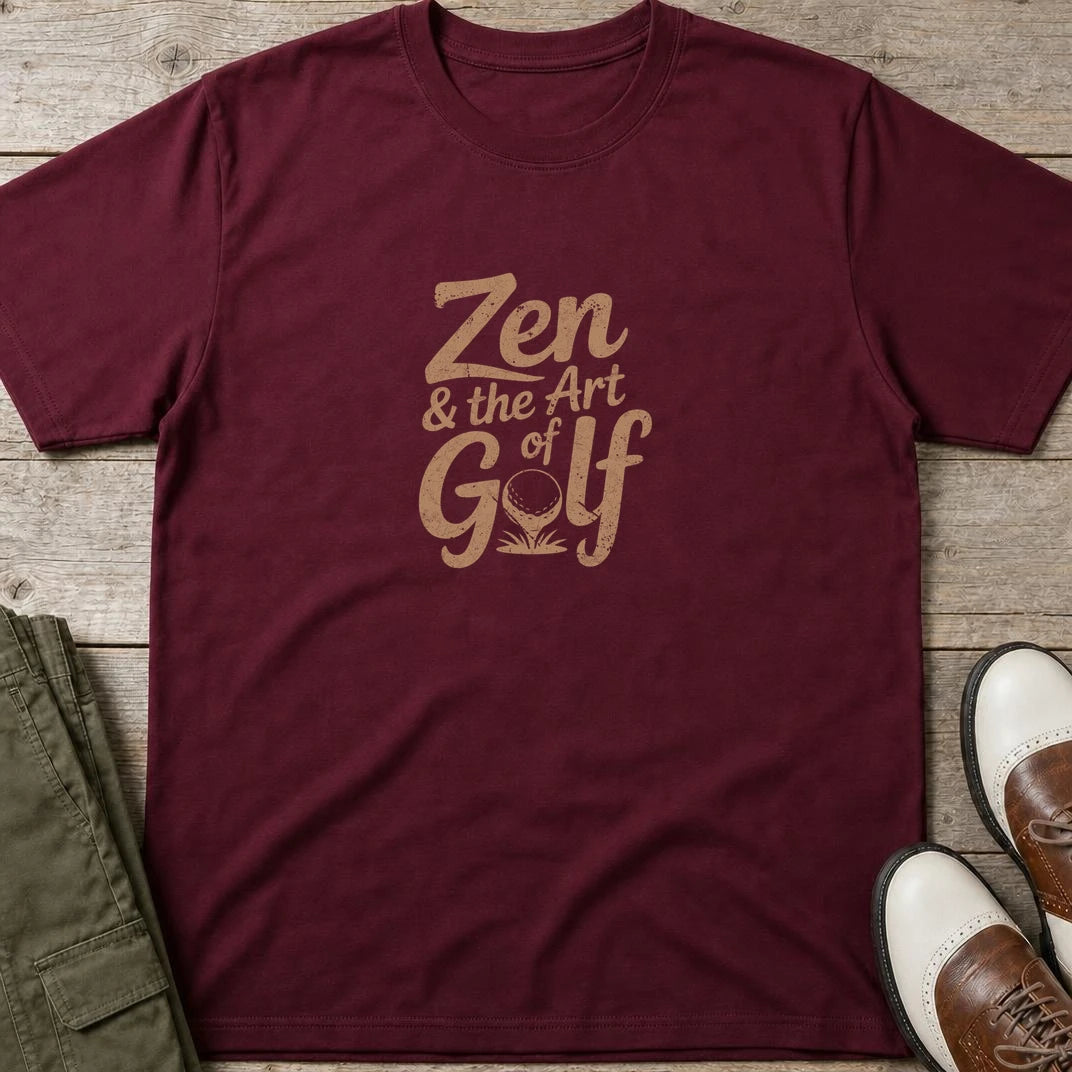 Zen Golf T-Shirt in Maroon lying on a plain floor. T-shirt is a unisex cut and 100 per cent cotton.