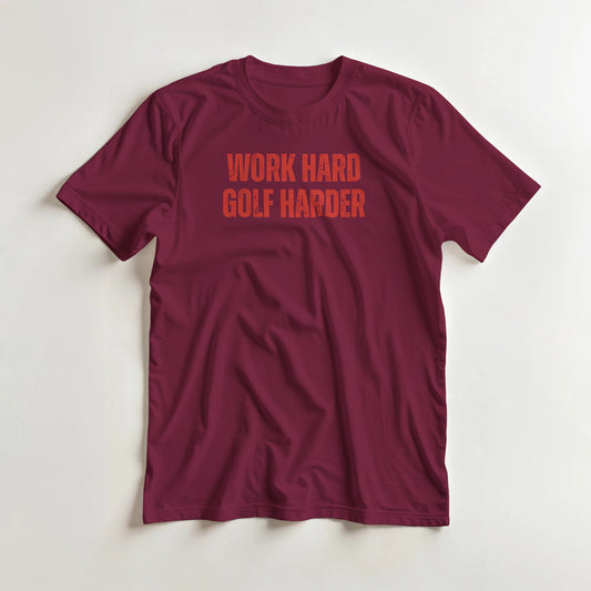 Golf Harder T-Shirt in Maroon S lying on a plain floor. T-shirt is a unisex cut and 100 per cent cotton.