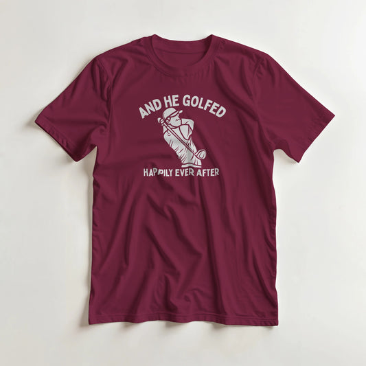 And He Golfed T-Shirt in Maroon lying on a plain floor. T-shirt is a unisex cut and 100 per cent cotton.