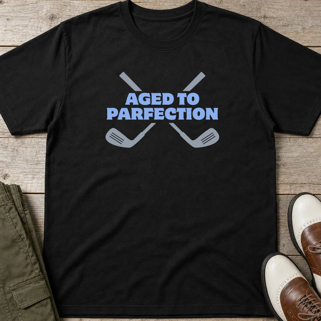 Parfection T-Shirt in Black lying on a plain floor. T-shirt is a unisex cut and 100 per cent cotton.