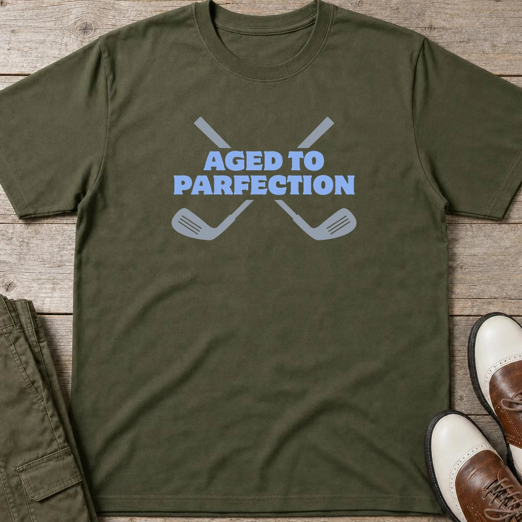Parfection T-Shirt in Military Green lying on a plain floor. T-shirt is a unisex cut and 100 per cent cotton.