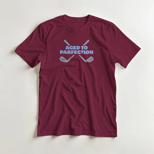 Parfection T-Shirt in Maroon lying on a plain floor. T-shirt is a unisex cut and 100 per cent cotton.