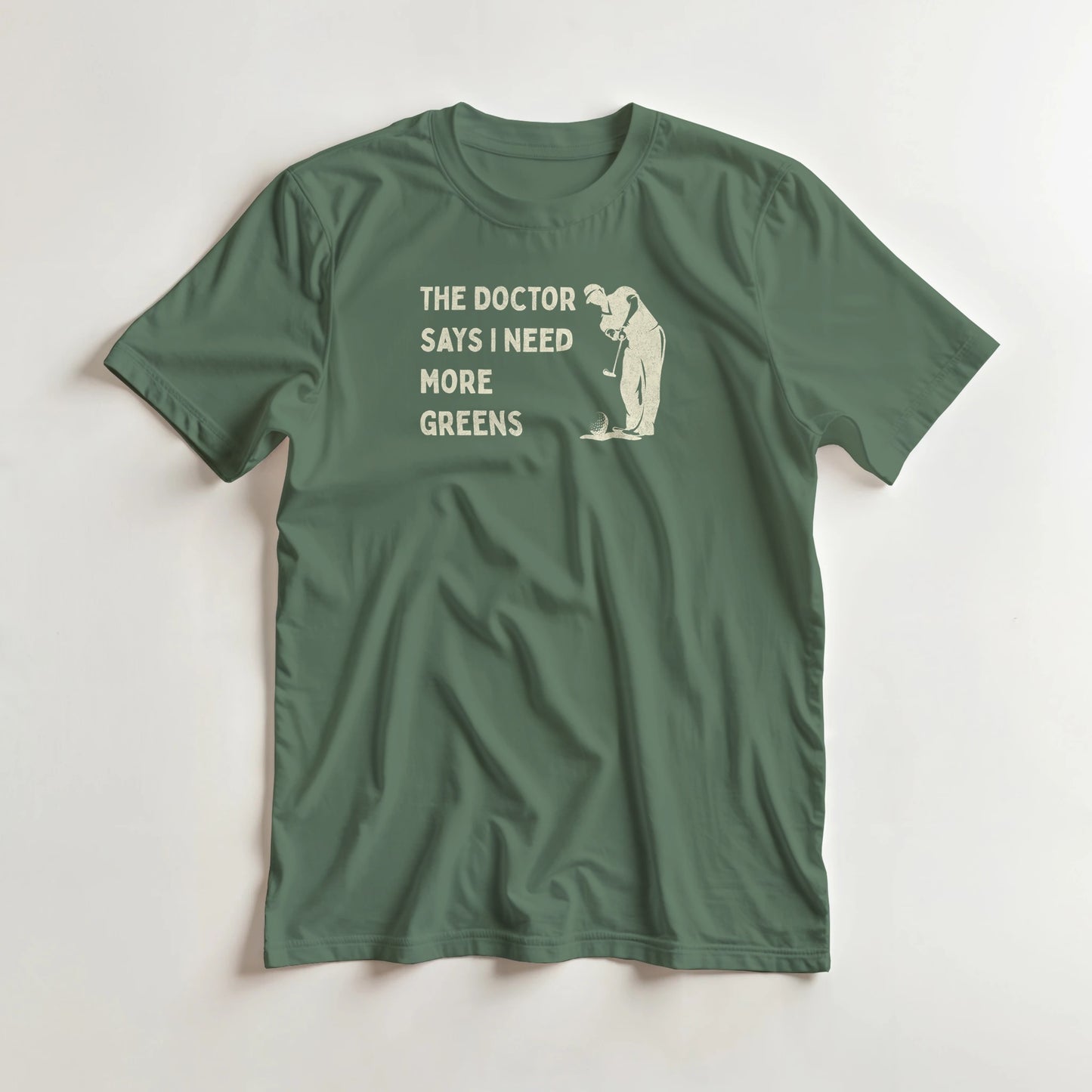 More Greens T-Shirt in Military Green lying on a plain floor. T-shirt is a unisex cut and 100 per cent cotton.