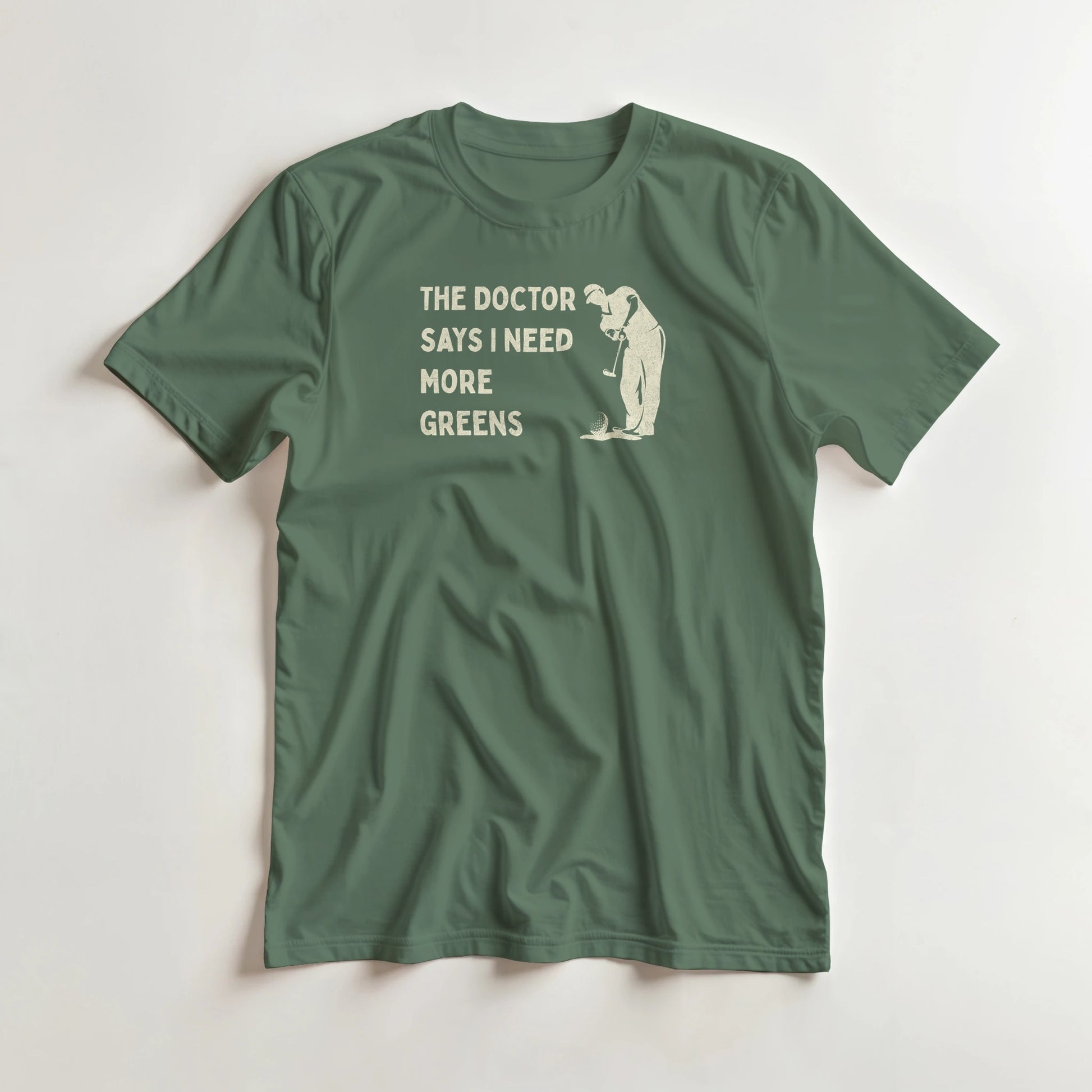 More Greens T-Shirt in Military Green lying on a plain floor. T-shirt is a unisex cut and 100 per cent cotton.