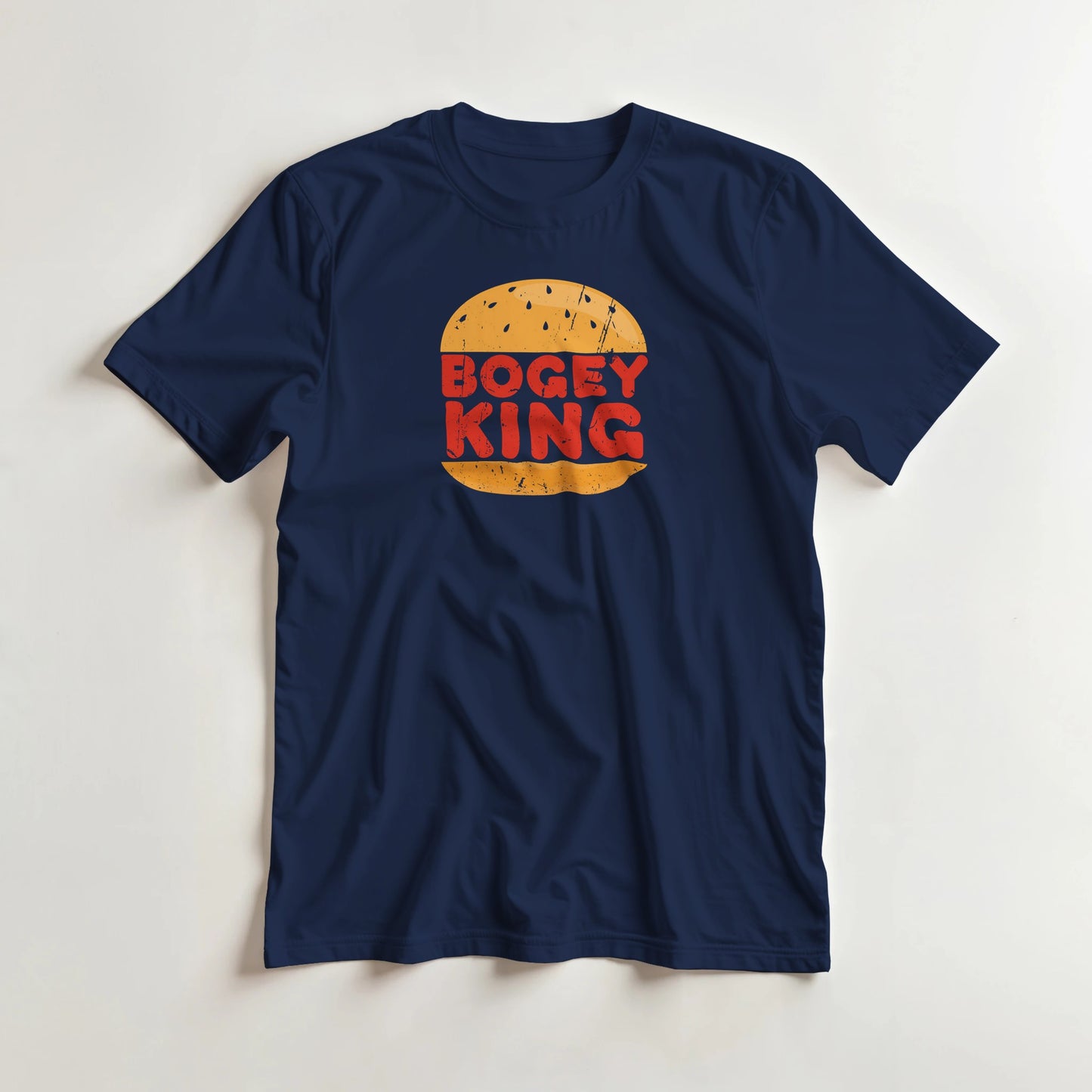 Bogey King T-Shirt in Navy lying on a plain floor. T-shirt is a unisex cut and 100 per cent cotton.