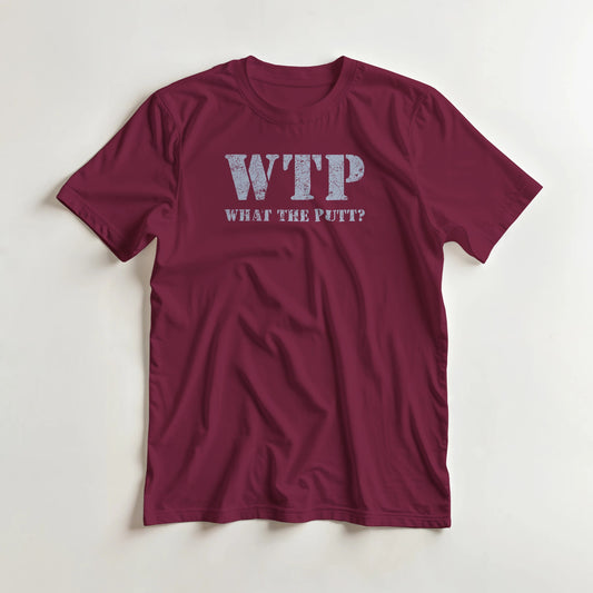 What The Putt T-Shirt in Maroon lying on a plain floor. T-shirt is a unisex cut and 100 per cent cotton.