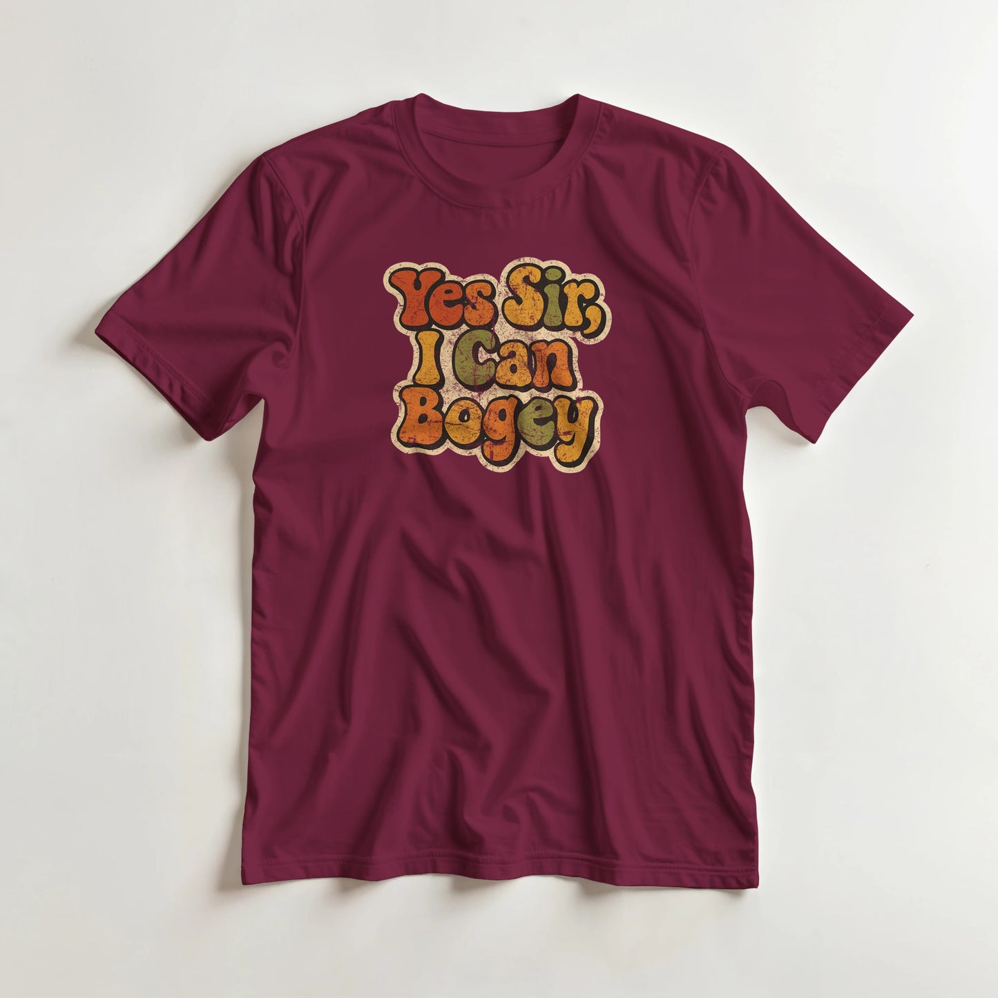 I Can Bogey T-Shirt in Maroon L lying on a plain floor. T-shirt is a unisex cut and 100 per cent cotton.