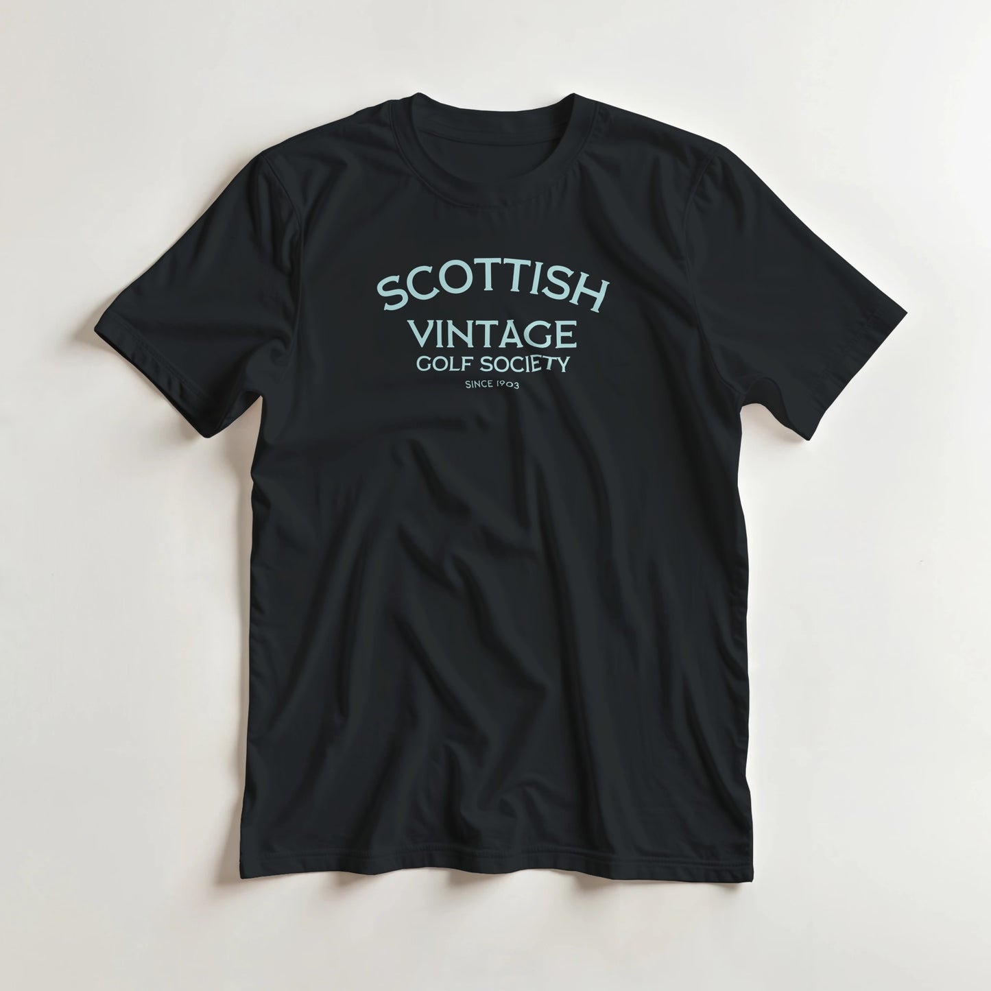 Scottish 1903 T-Shirt in Black lying on a plain floor. T-shirt is a unisex cut and 100 per cent cotton.