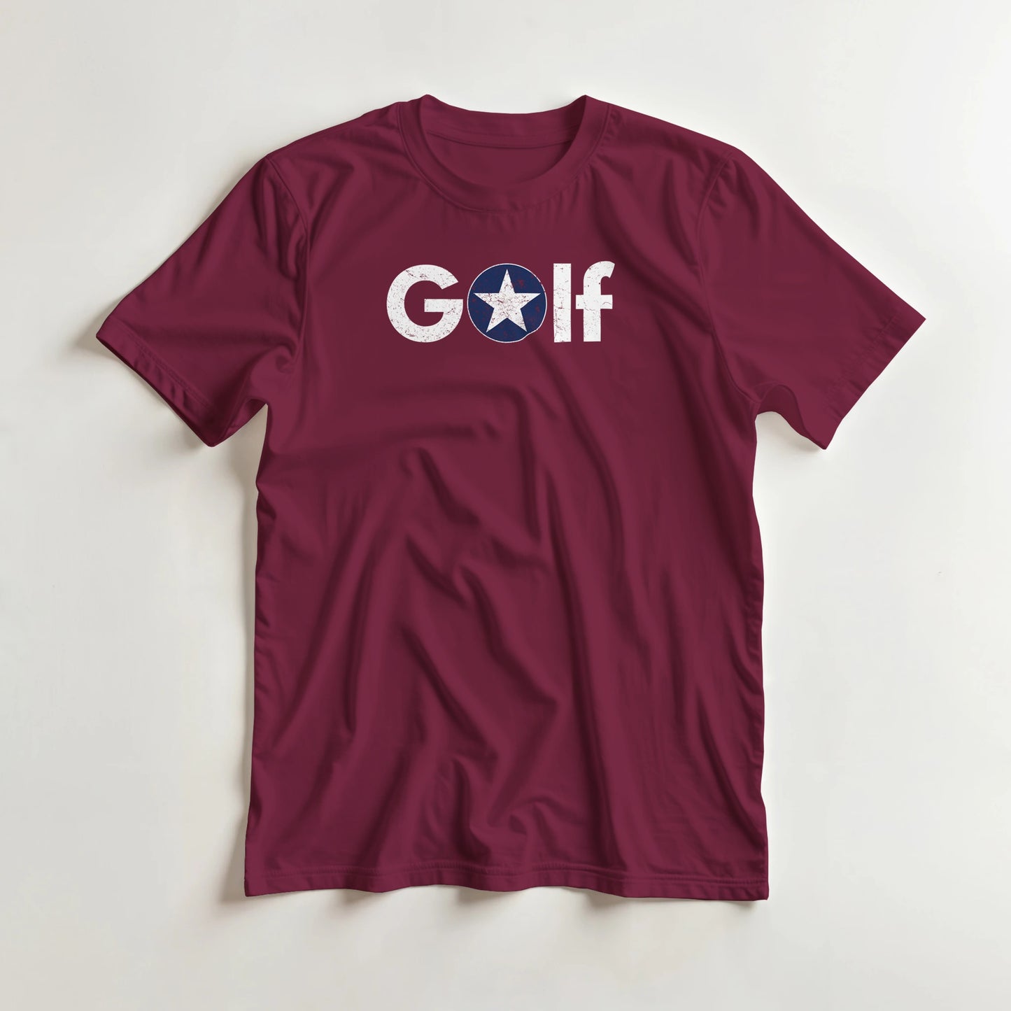 Golf Star T-Shirt in Maroon XL lying on a plain floor. T-shirt is a unisex cut and 100 per cent cotton.