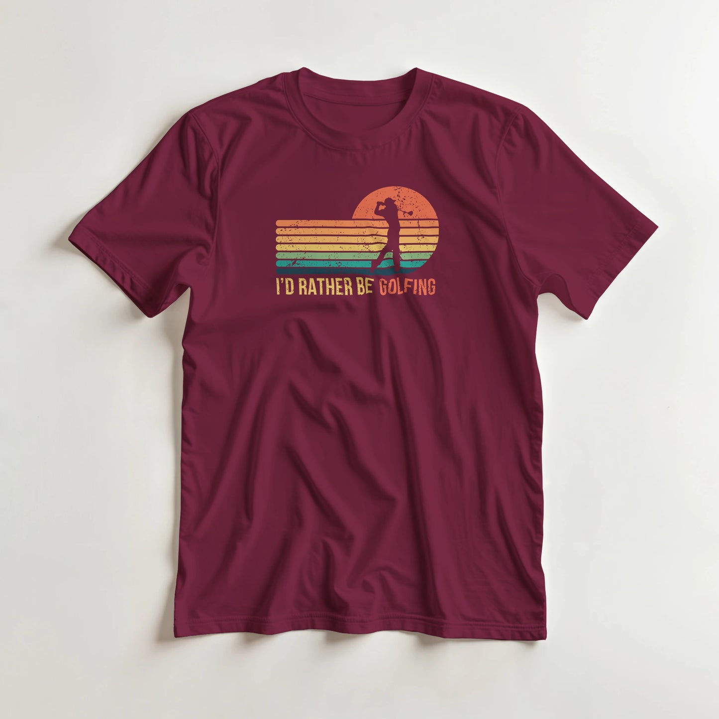Rather Be Golfing T-Shirt in Maroon 3XL lying on a plain floor. T-shirt is a unisex cut and 100 per cent cotton.