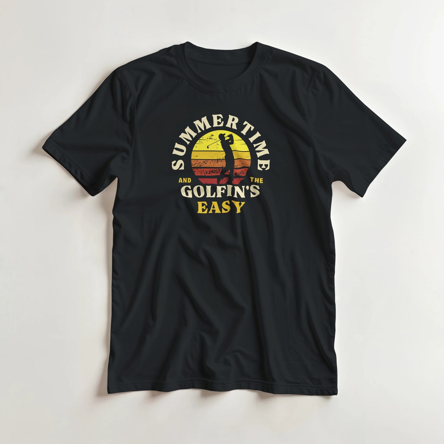 Summertime T-Shirt in Black lying on a plain floor. T-shirt is a unisex cut and 100 per cent cotton.