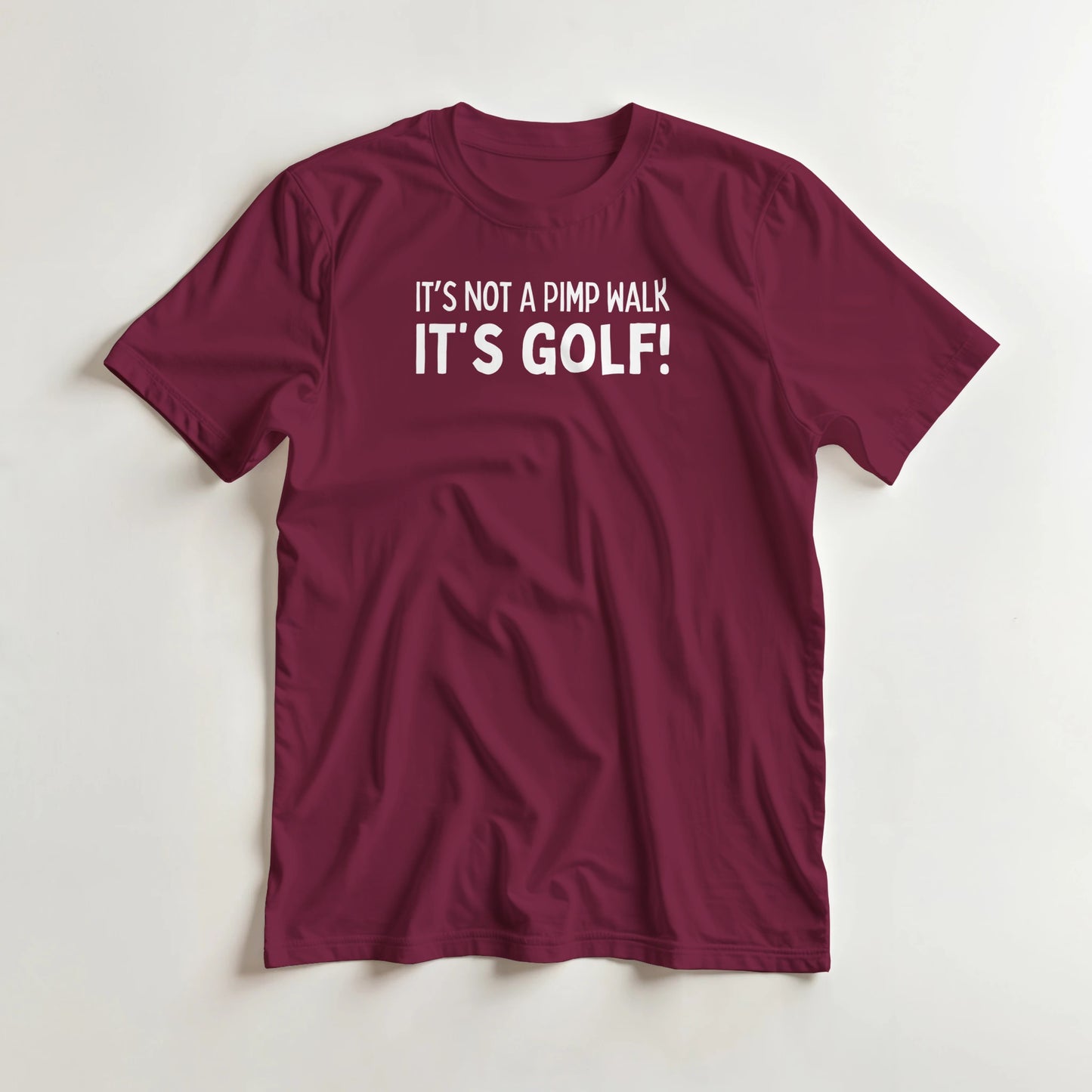 Not A Pimp Walk T-Shirt in Maroon lying on a plain floor. T-shirt is a unisex cut and 100 per cent cotton.