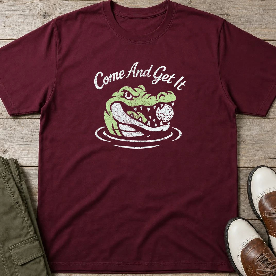 Come And Get It T-Shirt in Maroon lying on a plain floor. T-shirt is a unisex cut and 100 per cent cotton.