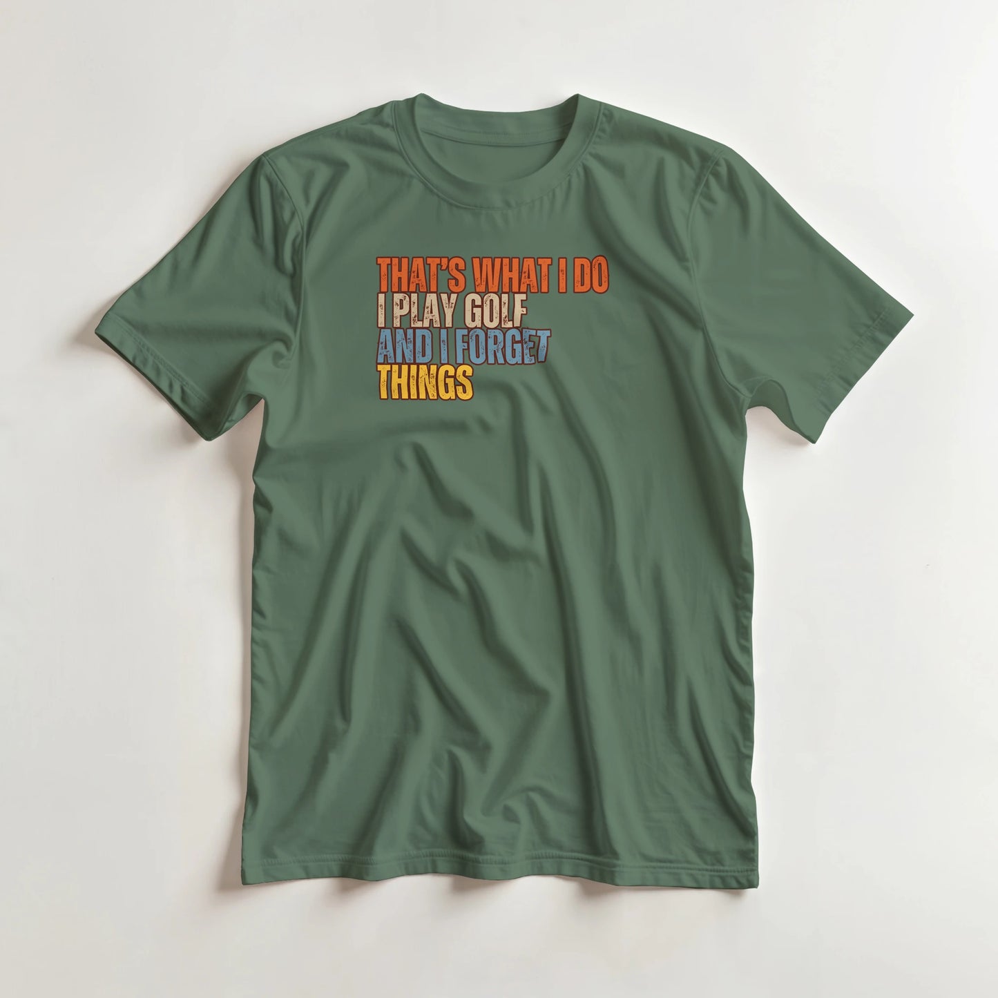 What I Do T-Shirt in Military Green lying on a plain floor. T-shirt is a unisex cut and 100 per cent cotton.