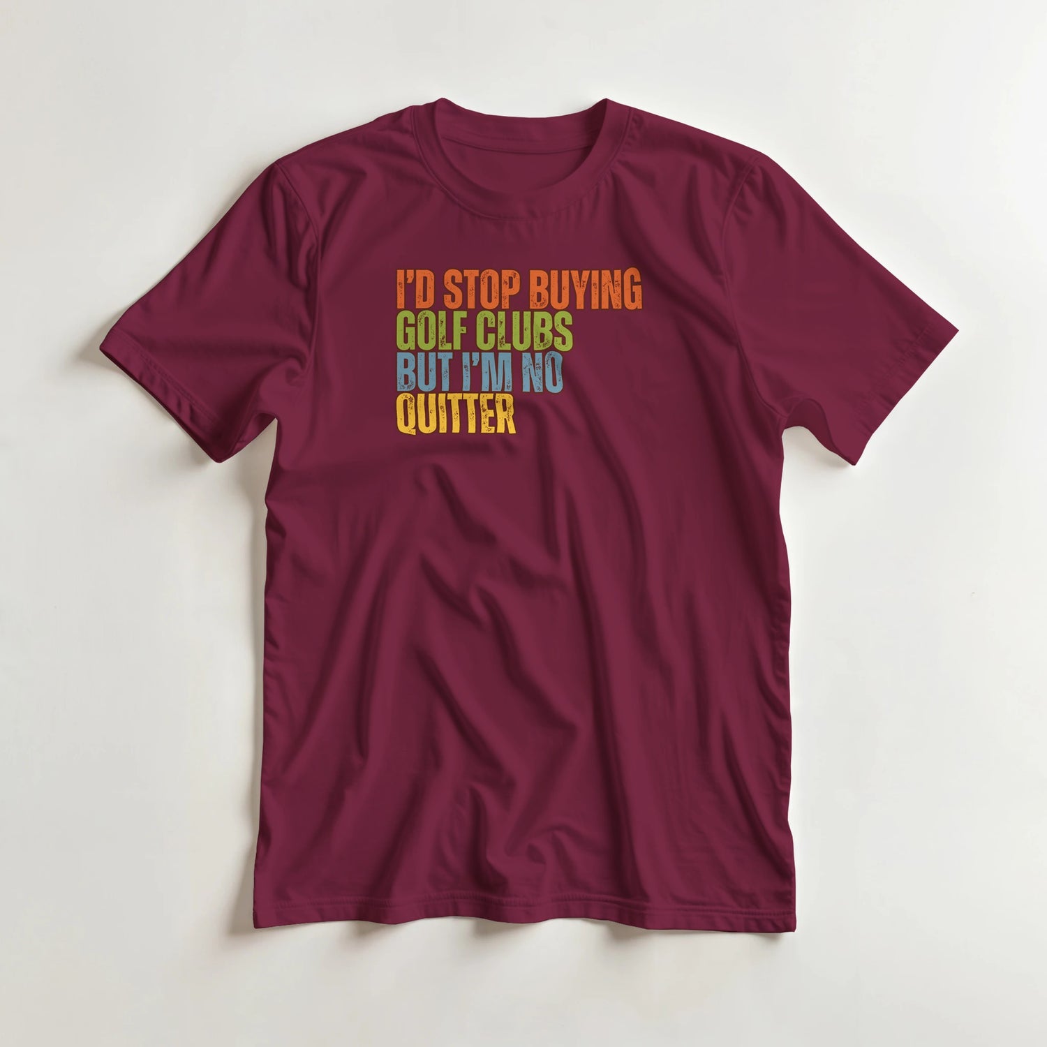 I'd Stop T-Shirt in Maroon lying on a plain floor. T-shirt is a unisex cut and 100 per cent cotton.