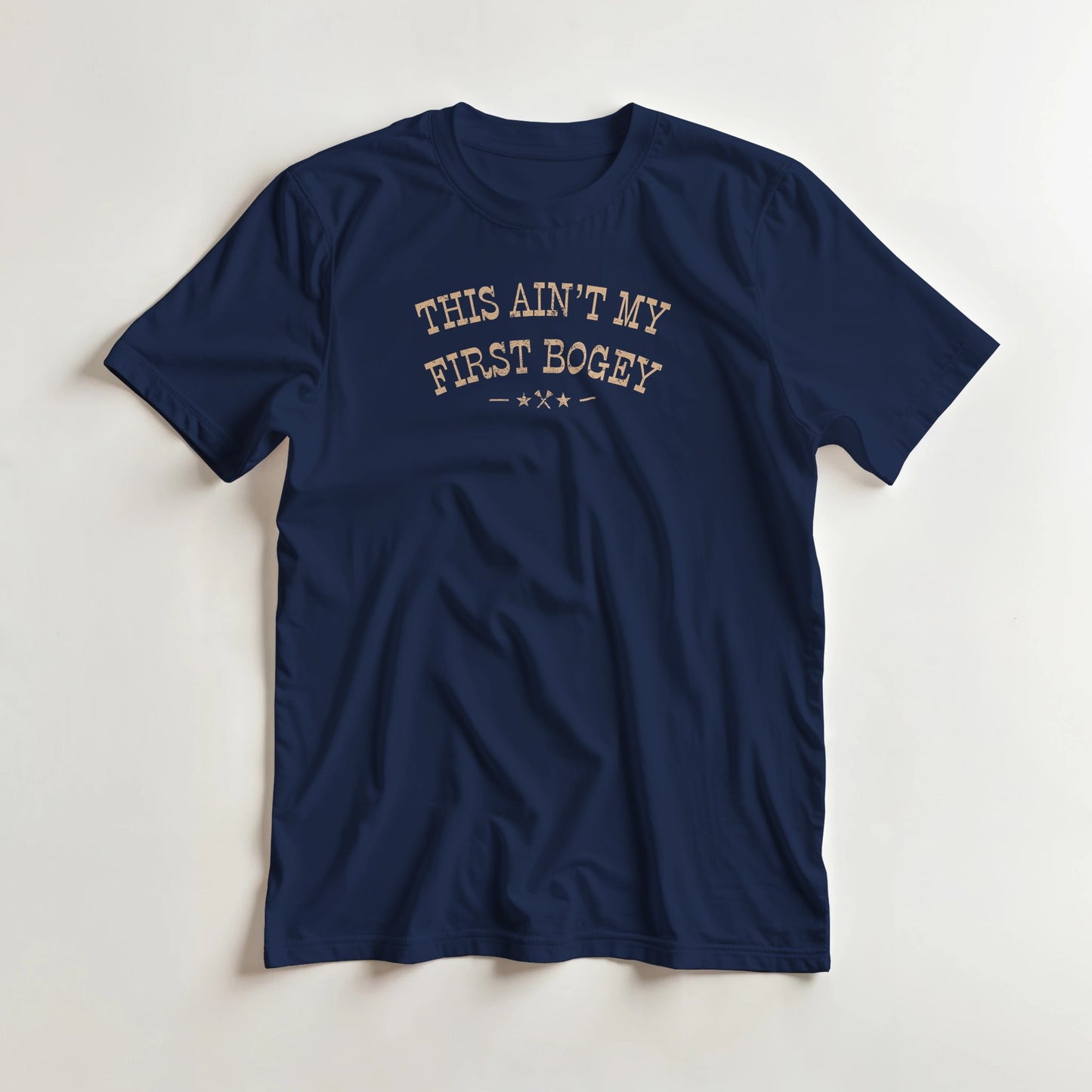 First Bogey T-Shirt in Navy lying on a plain floor. T-shirt is a unisex cut and 100 per cent cotton.