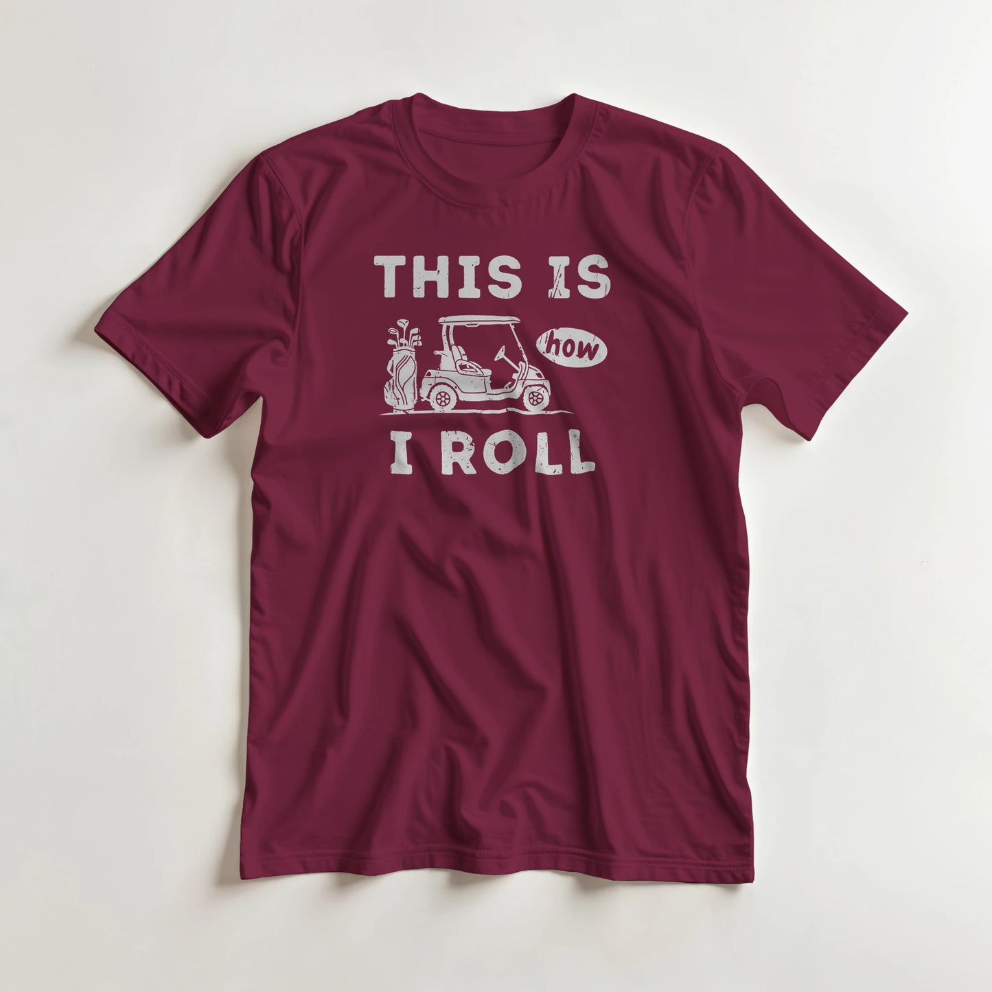 How I Roll T-Shirt in Maroon lying on a plain floor. T-shirt is a unisex cut and 100 per cent cotton.