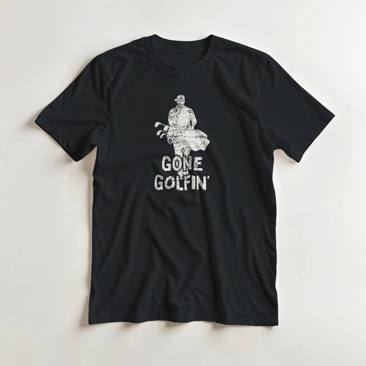 Gone Golfin' T-Shirt in Black lying on a plain floor. T-shirt is a unisex cut and 100 per cent cotton.