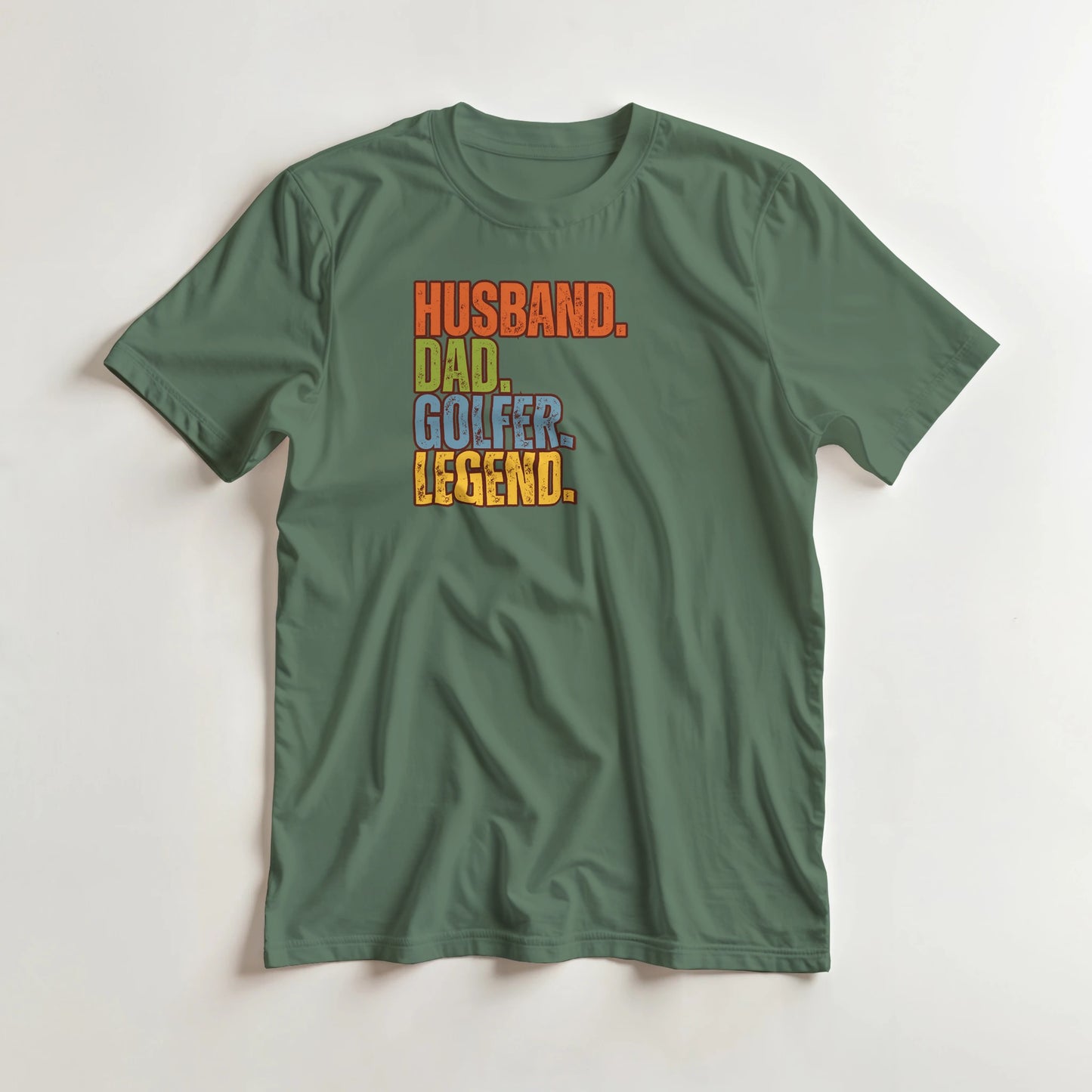 Husband Dad T-Shirt in Military Green lying on a plain floor. T-shirt is a unisex cut and 100 per cent cotton.