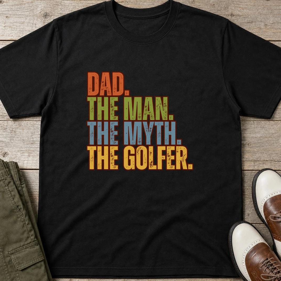 Dad The Legend Golfer T-Shirt in Black lying on a plain floor. T-shirt is a unisex cut and 100 per cent cotton.
