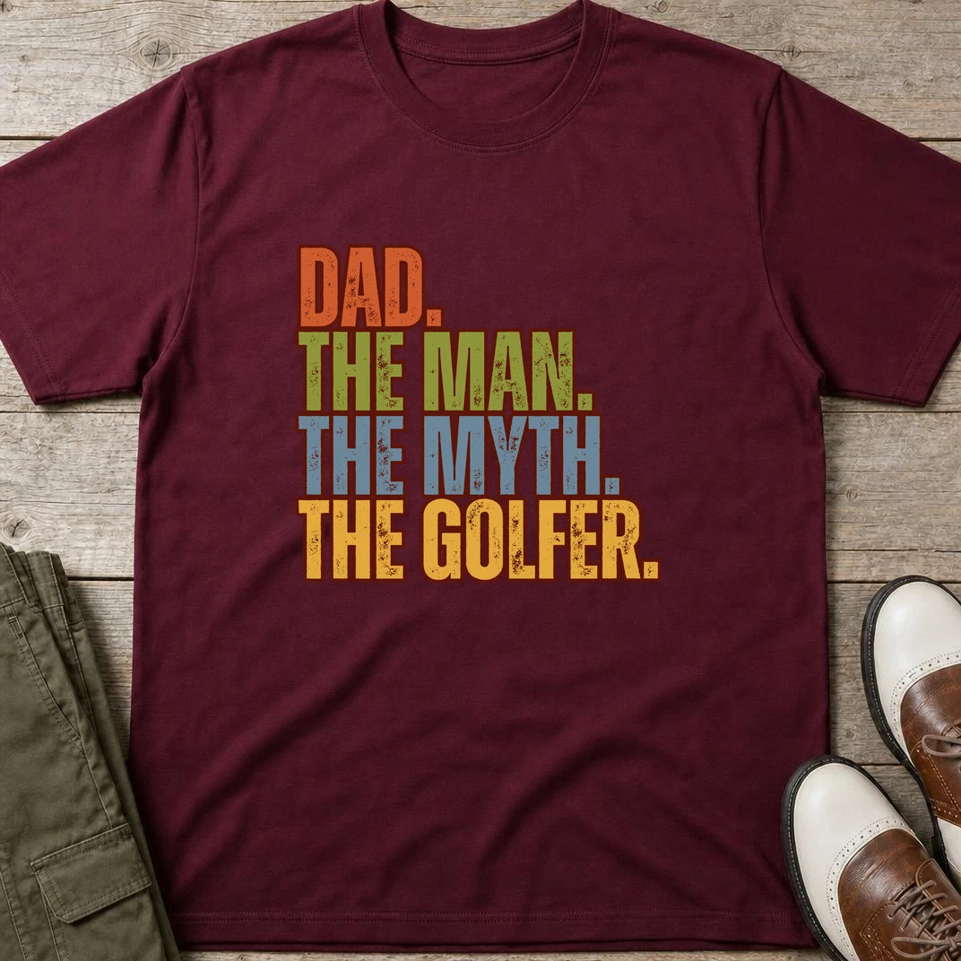Dad The Legend Golfer T-Shirt in Maroon lying on a plain floor. T-shirt is a unisex cut and 100 per cent cotton.