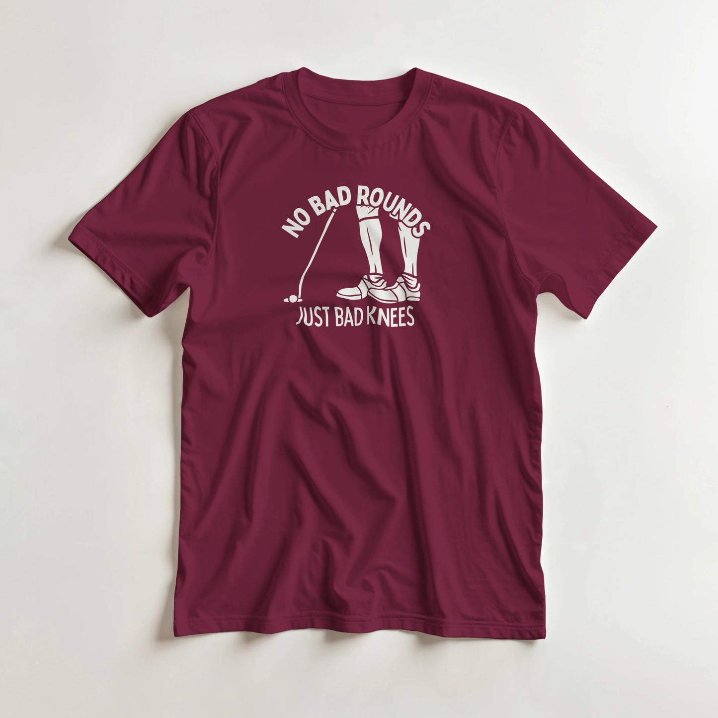 No Bad Rounds T-Shirt in Maroon lying on a plain floor. T-shirt is a unisex cut and 100 per cent cotton.