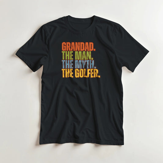 Grandad Golfer T-Shirt in Black lying on a plain floor. T-shirt is a unisex cut and 100 per cent cotton.