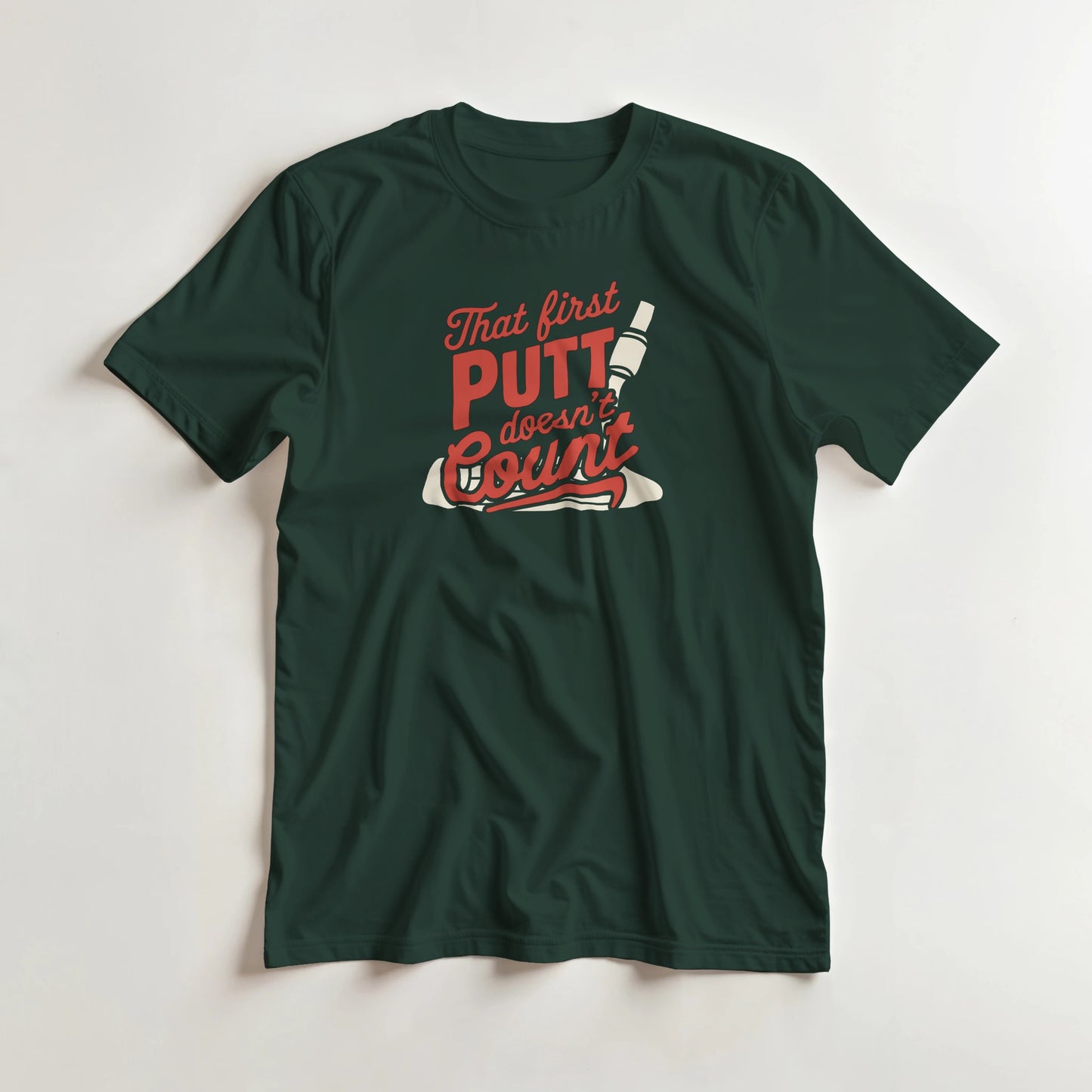 First Putt T-Shirt in Forest Green lying on a plain floor. T-shirt is a unisex cut and 100 per cent cotton.