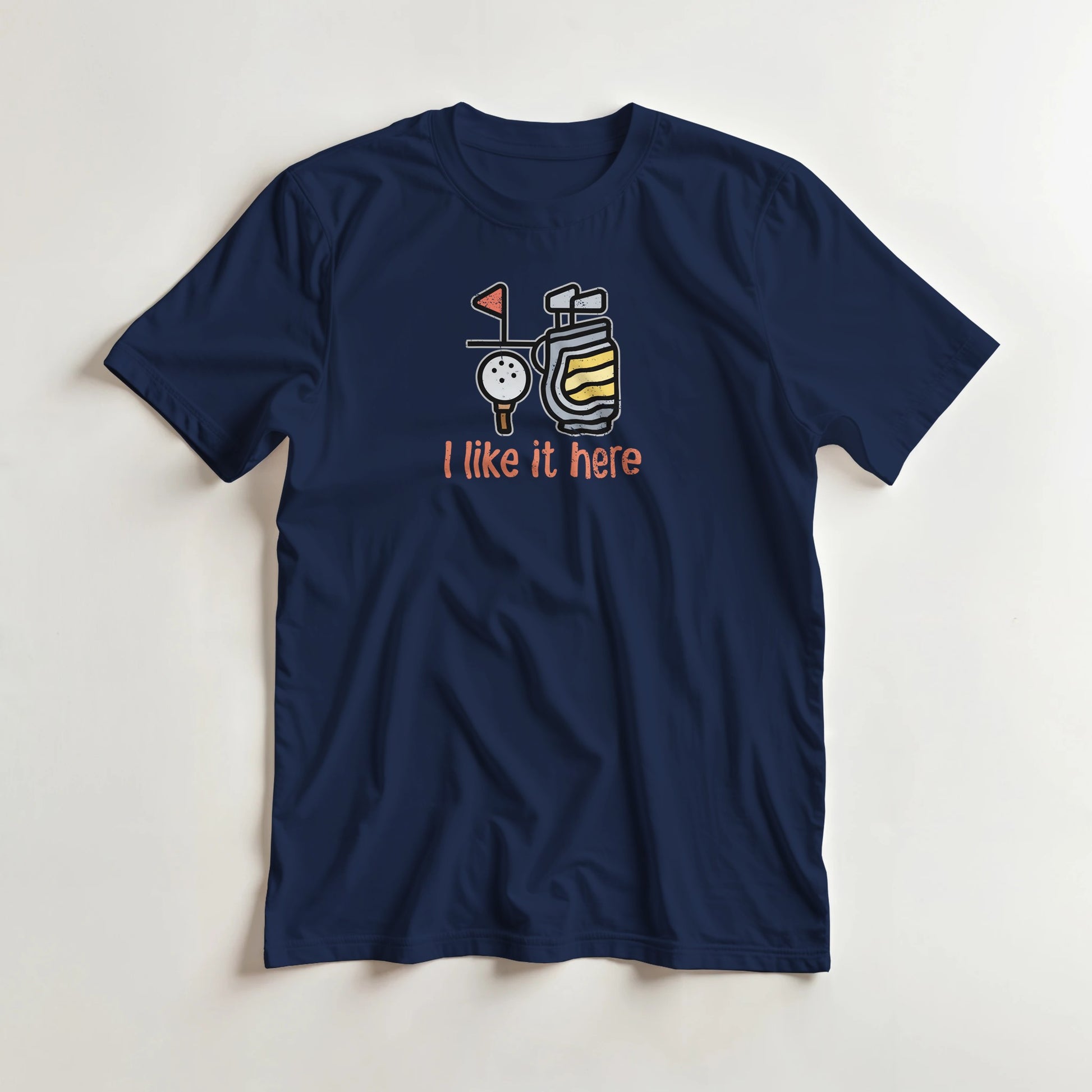 I Like It Here T-Shirt in Navy lying on a plain floor. T-shirt is a unisex cut and 100 per cent cotton.