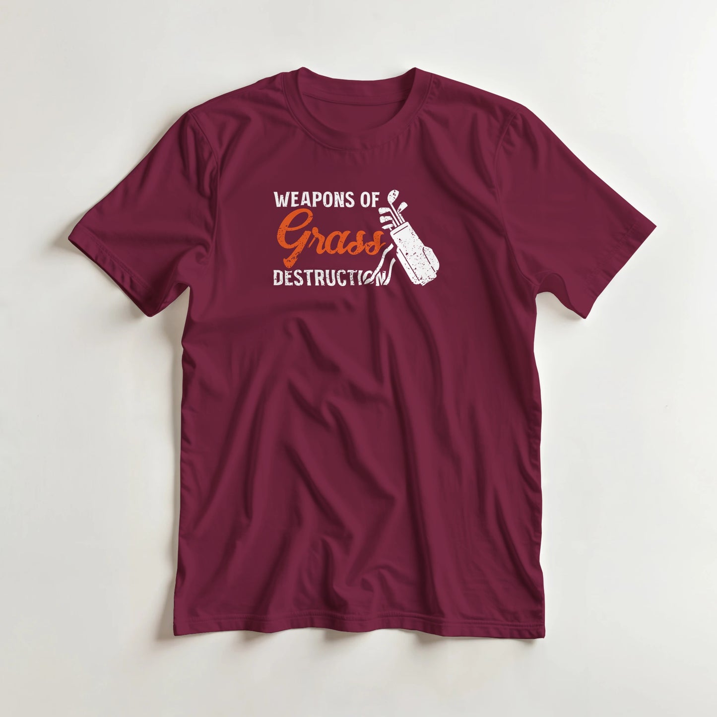 Weapons T-Shirt in Maroon S lying on a plain floor. T-shirt is a unisex cut and 100 per cent cotton.