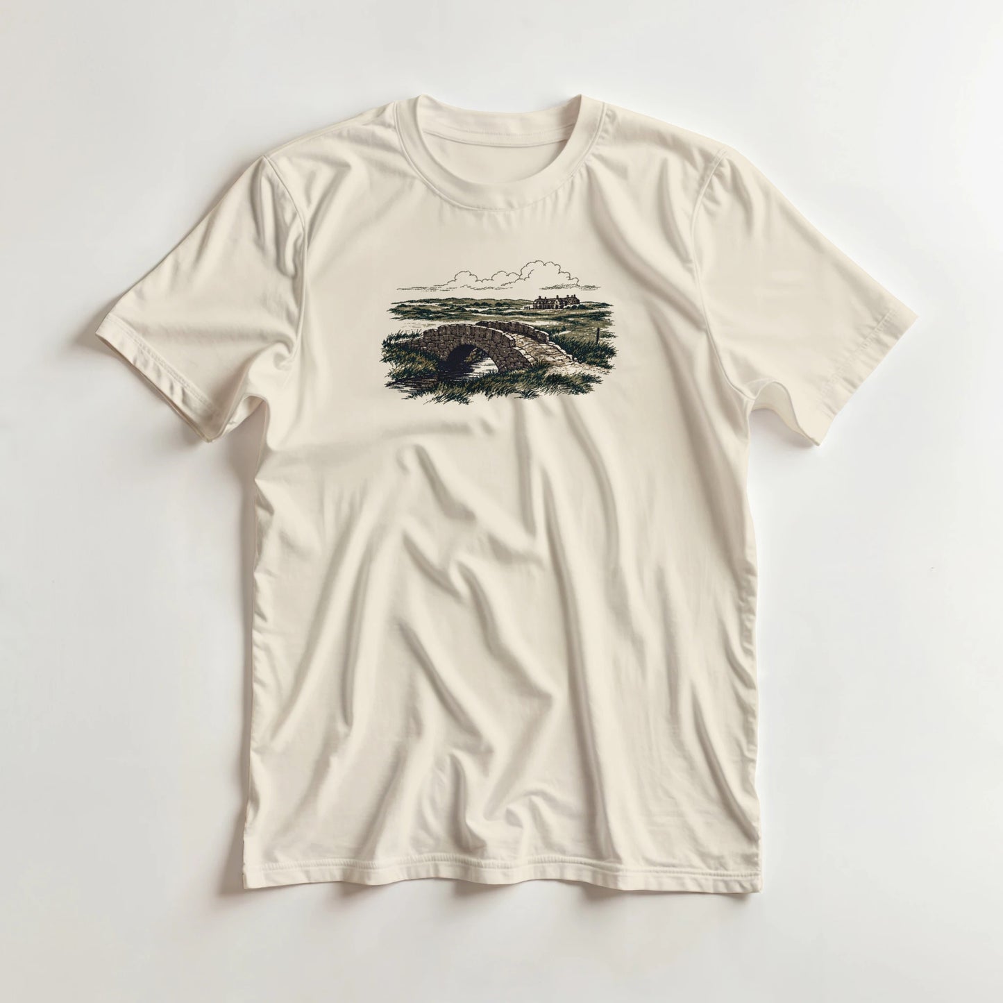 The Burn T-Shirt in Natural lying on a plain floor. T-shirt is a unisex cut and 100 per cent cotton.