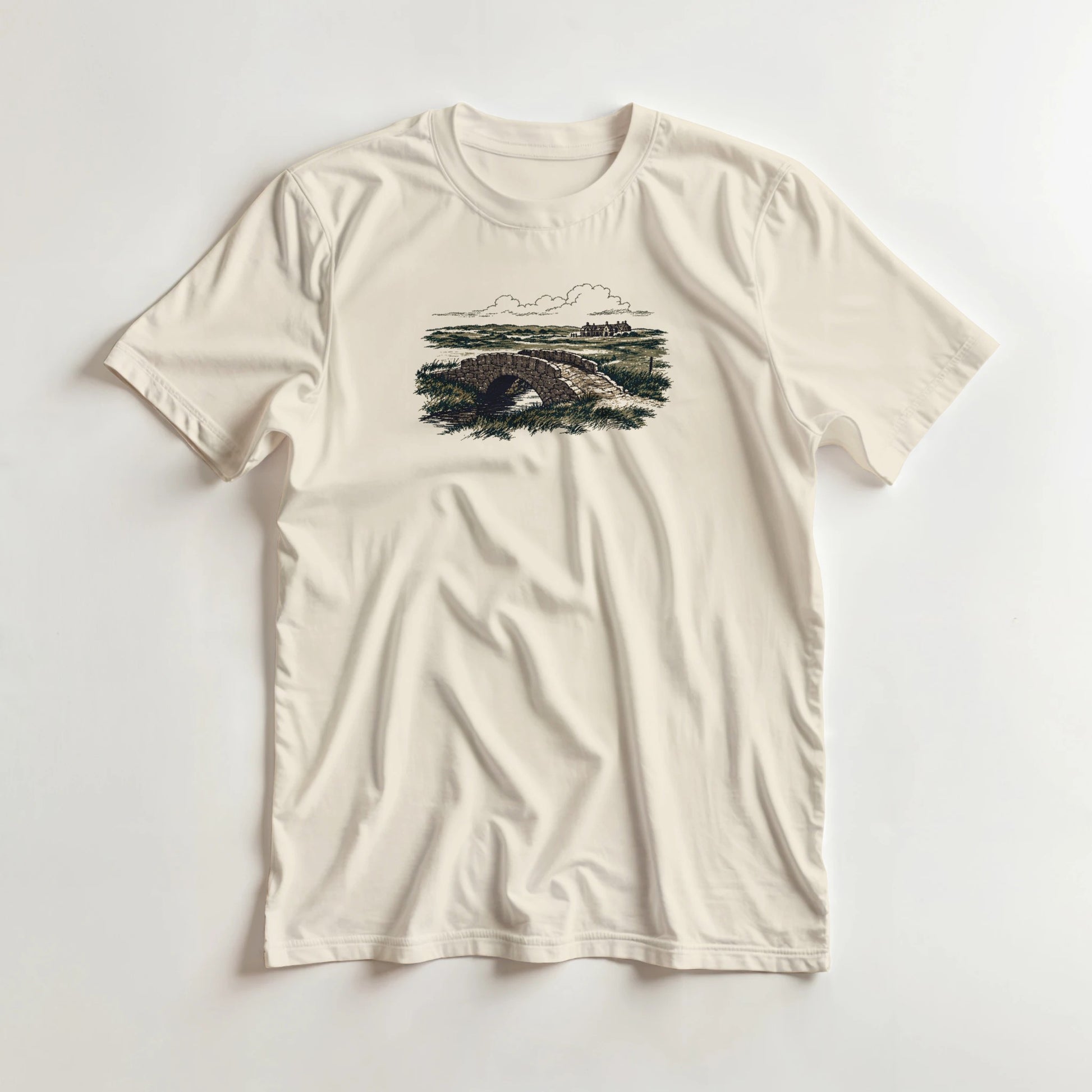 The Burn T-Shirt in Natural lying on a plain floor. T-shirt is a unisex cut and 100 per cent cotton.