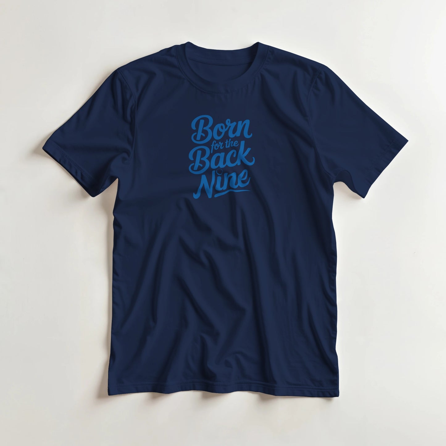 Back Nine T-Shirt in Navy lying on a plain floor. T-shirt is a unisex cut and 100 per cent cotton.