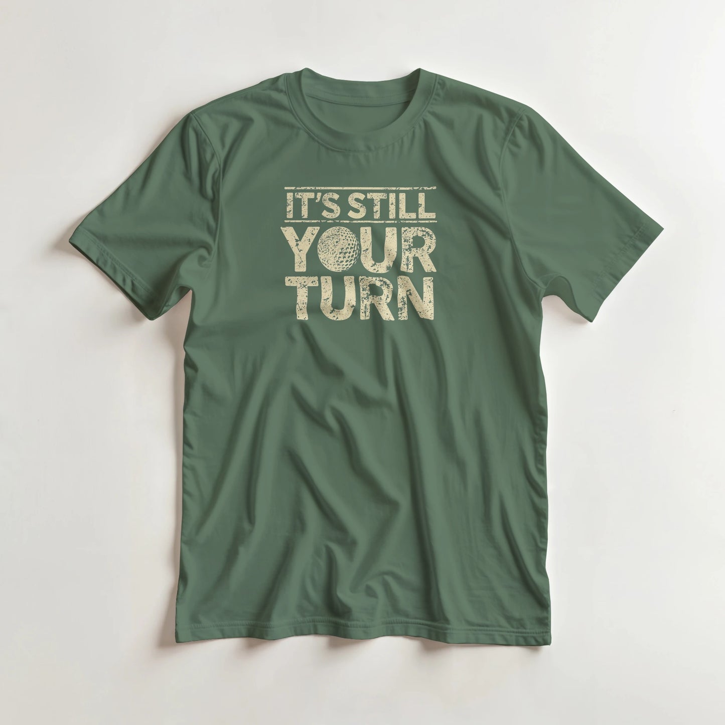 Your Turn T-Shirt in Military Green lying on a plain floor. T-shirt is a unisex cut and 100 per cent cotton.