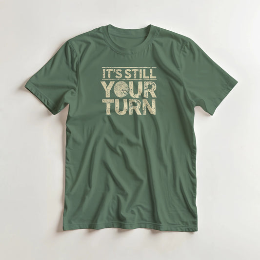 Your Turn T-Shirt in Military Green lying on a plain floor. T-shirt is a unisex cut and 100 per cent cotton.